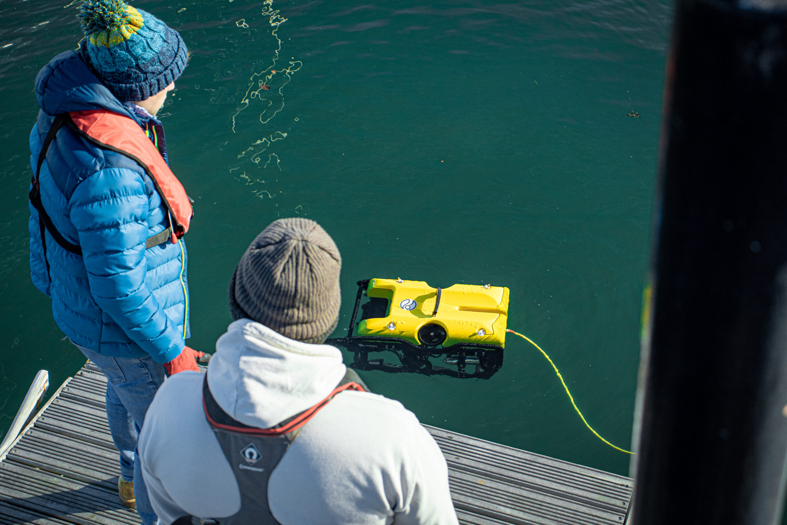 People observing an ROV beneath the ocean's surface as it goes about analysing the potential for ARC Marine's nature inclusive solutions.